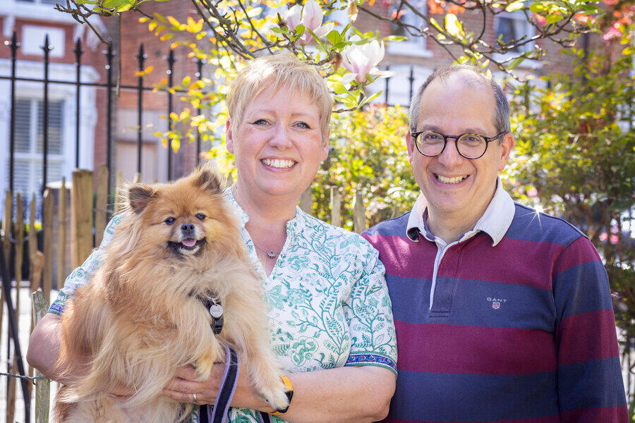 photograph of Callie Di Nello, Emilio Di Nello and Siena Luna, their Pomeranian dog, against a magnolia tree in South West London, UK